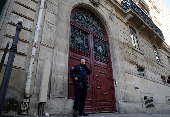 A police officer stands guard at the entrance of a luxury residence on the Rue Tronchet in central Paris, France, Oct. 3, 201