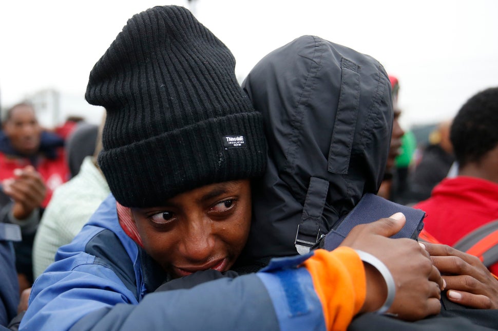 An Ethiopian migrant, member of the Oromo community, cries as he leaves the "Jungle."