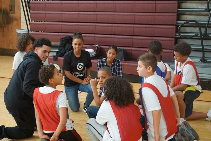 College and High School students leading team huddle.