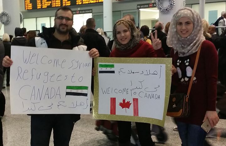 At Toronto's international airport, people gather to welcome new arrivals from Syria on Dec. 9, 2015. 