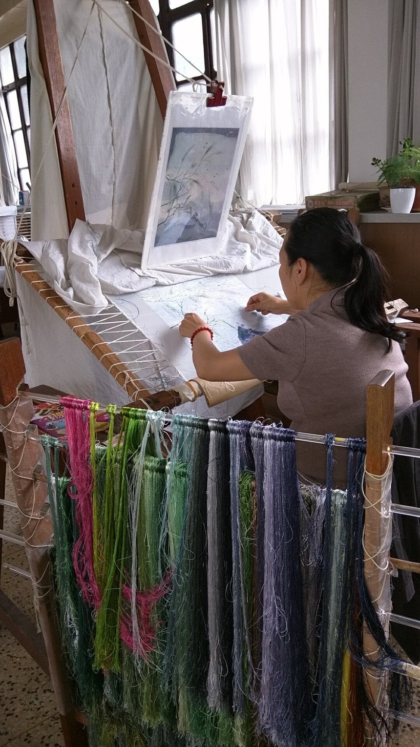 Masters create pictures from fine silk threads