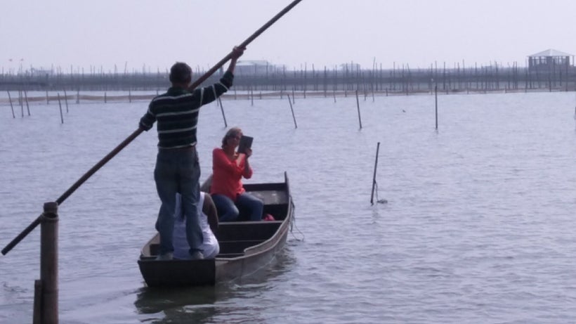 Visitors go out in boats to the crab cages