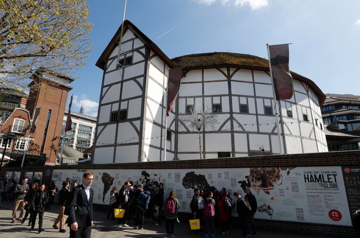 A view The Globe Theatre nestled alongside contemporary buildings on the banks of the River Thames in London