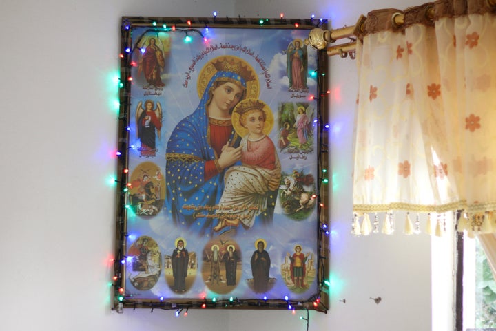 A portrait of the Virgin Mary and Jesus hangs in a family's home in Maghara, Iraq. 