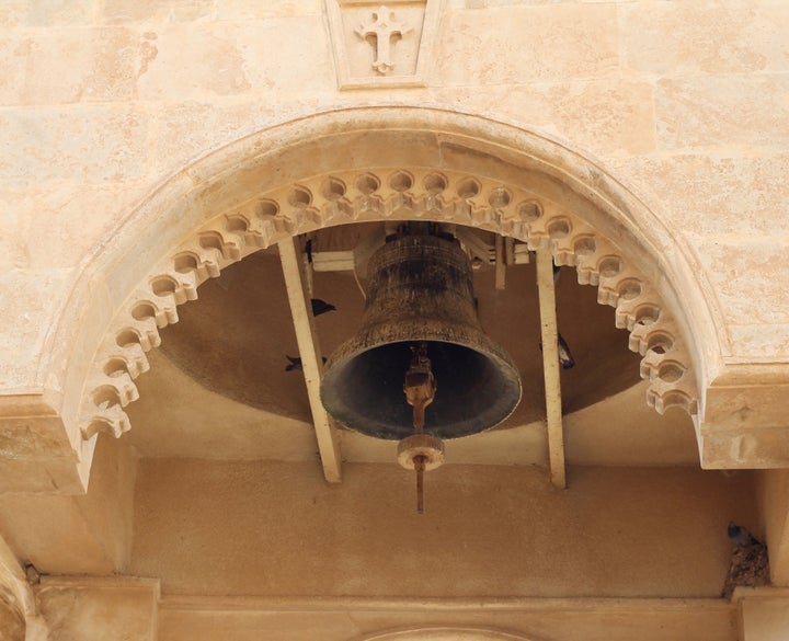 Birds perch and sing inside of a bell tower at Mar Mattai Monastery.