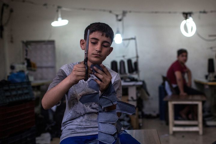A Syrian refugee child works in a Syrian-owned clothing factory on May 17, 2016 in Gaziantep, Turkey.