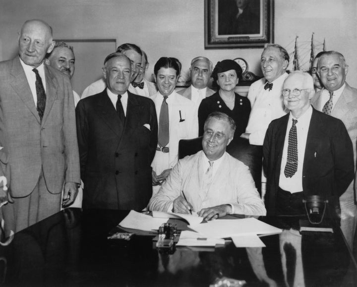 President Franklin Delano Roosevelt signs the Social Security Act on Aug. 14, 1935.