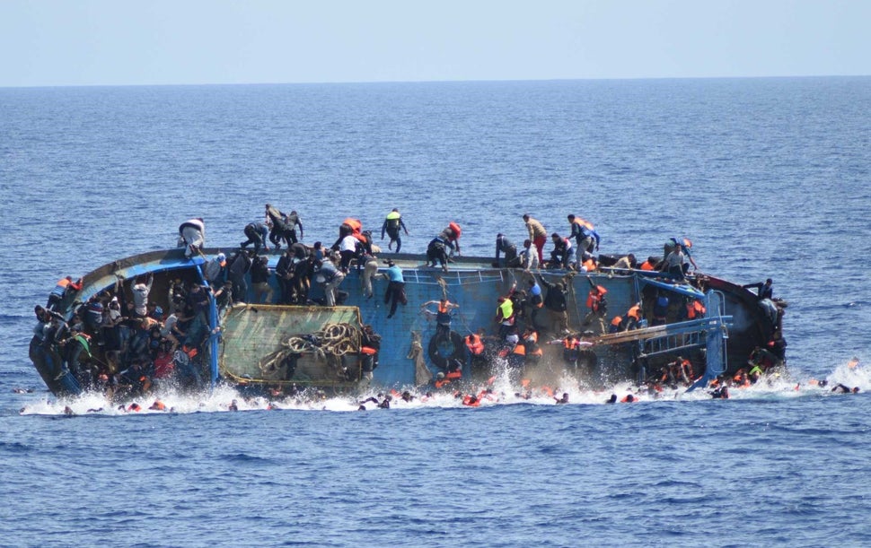 A migrant boat capsizes in the&nbsp;Sicilian Strait, between Libya and Italy, on May 25.