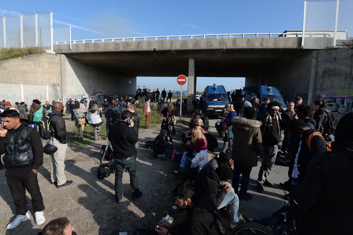 A police cordon at the bridge near the camp's entrance, as fires raged on Wednesday