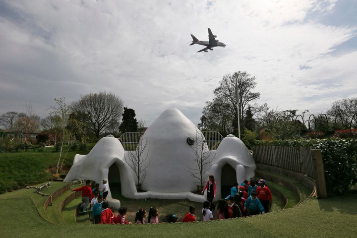 An aircraft descends overhead at Hounslow Heath Infants' School near to Heathrow