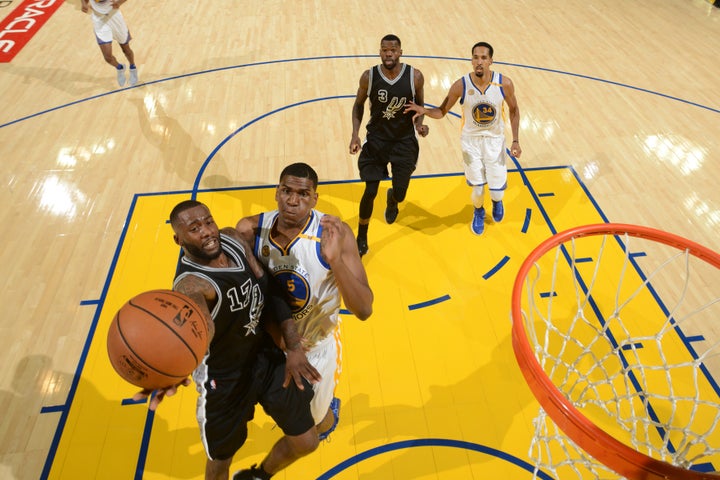 Jonathon Simmons drives to the basket against Kevon Looney on Oct. 25, 2016, at Oracle Arena in Oakland, California