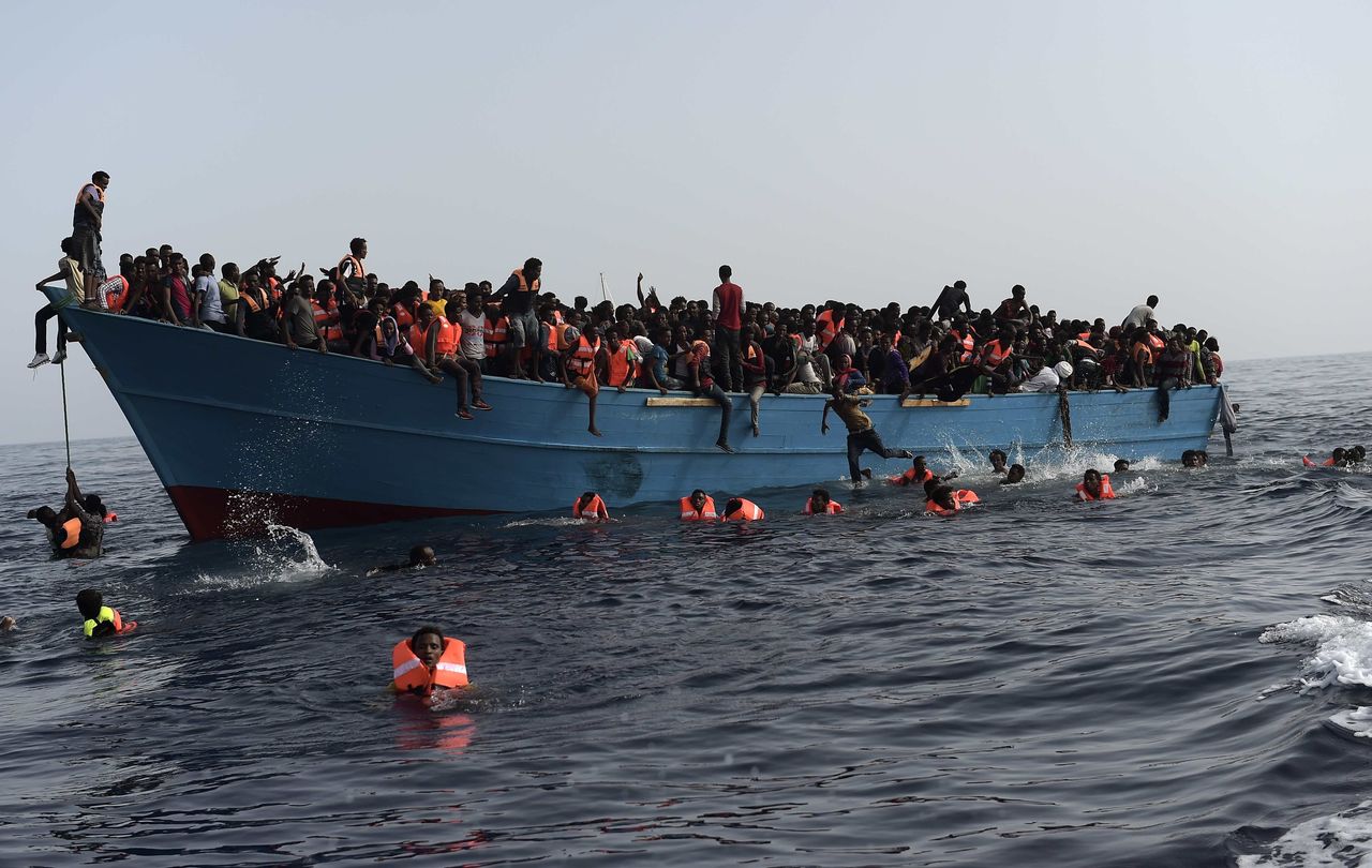 Refugees and migrants wait to be rescued by Proactiva Open Arms NGO in the Mediterranean Sea, some 12 miles north of Libya, on Oct. 4.