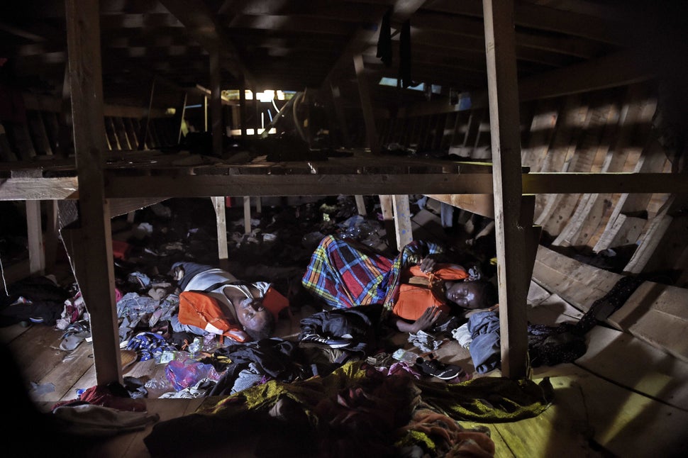 Dead bodies lie on the bottom level of a third-level wooden vessel, during a rescue operation, some 12 miles north of Libya o