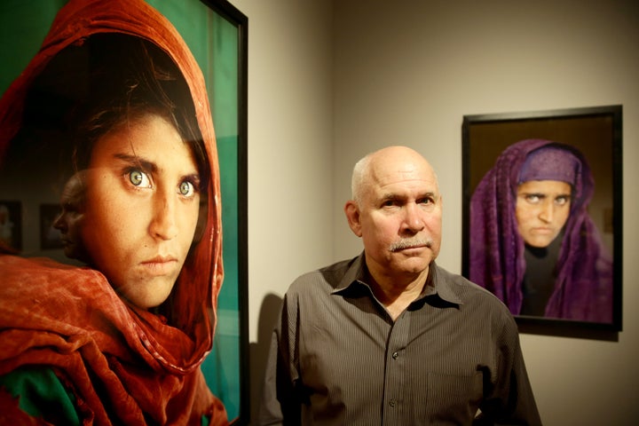 U.S. photographer Steve McCurry beside his famous "Afghan Girl" portrait of Sharbat Gula in 2013. It's been compared to Leonardo Da Vinci’s painting The Mona Lisa because her green-eyed stare is so haunting.