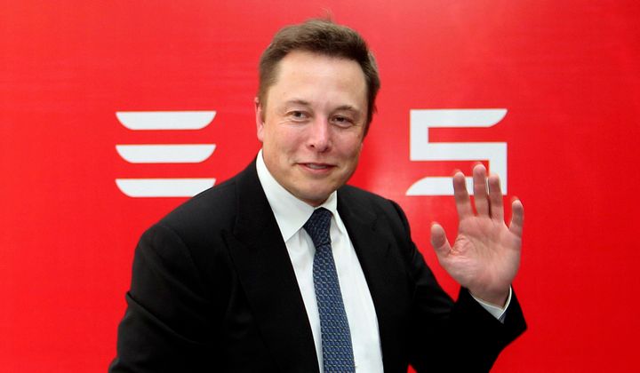 Tesla Motors CEO Elon Musk waves during a news conference to mark the company's delivery of the first batch of electric cars to Chinese customers in Beijing on April 22, 2014.
