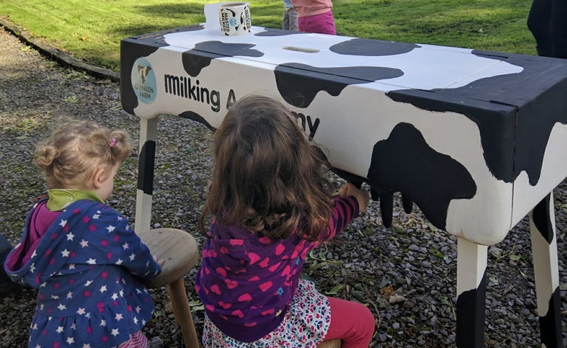 Young guests practice milking