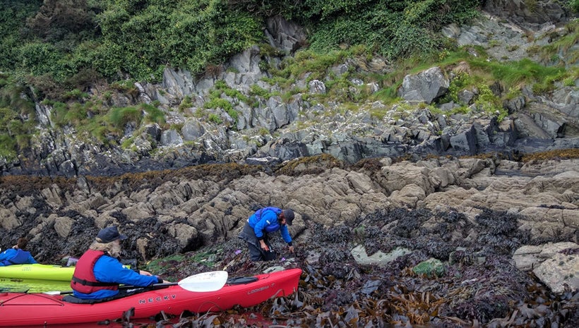 Maria scrambled on the rocks collecting samples