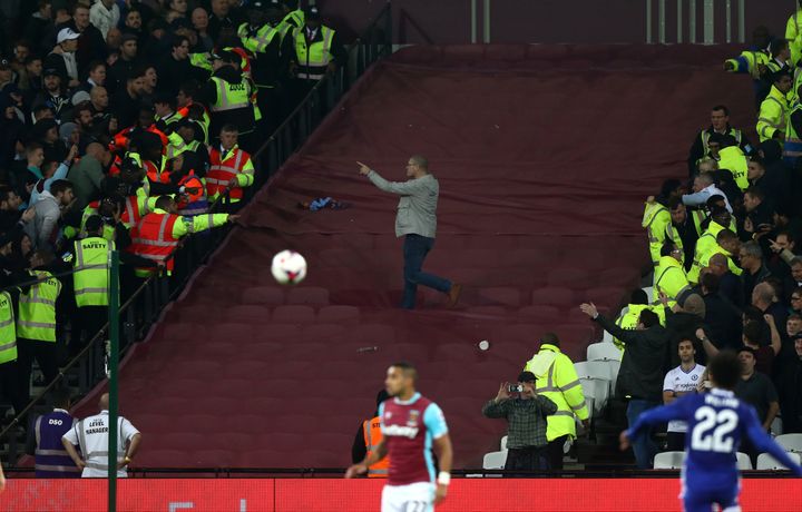 Stewards struggled to maintain segregation behind the Hammers’ goal towards the end of the match; a Chelsea fan is pictured above breaching the police line