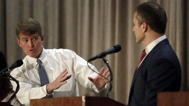 Missouri Democratic gubernatorial candidate Chris Koster, left, speaks to Republican candidate Eric Greitens during their fir