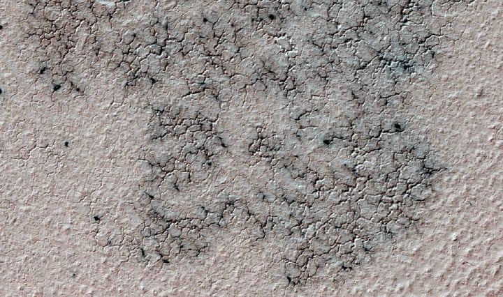 The image shows spidery channels eroded into the Martian ground. It's an example from high resolution observation of more tha