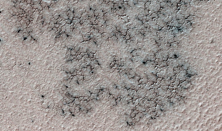 The image shows spidery channels eroded into the Martian ground. It's an example from high resolution observation of more than 20 places that were chosen in 2016 on the basis of about 10,000 volunteers' examination of lower resolution images of large areas near Mars' south pole.