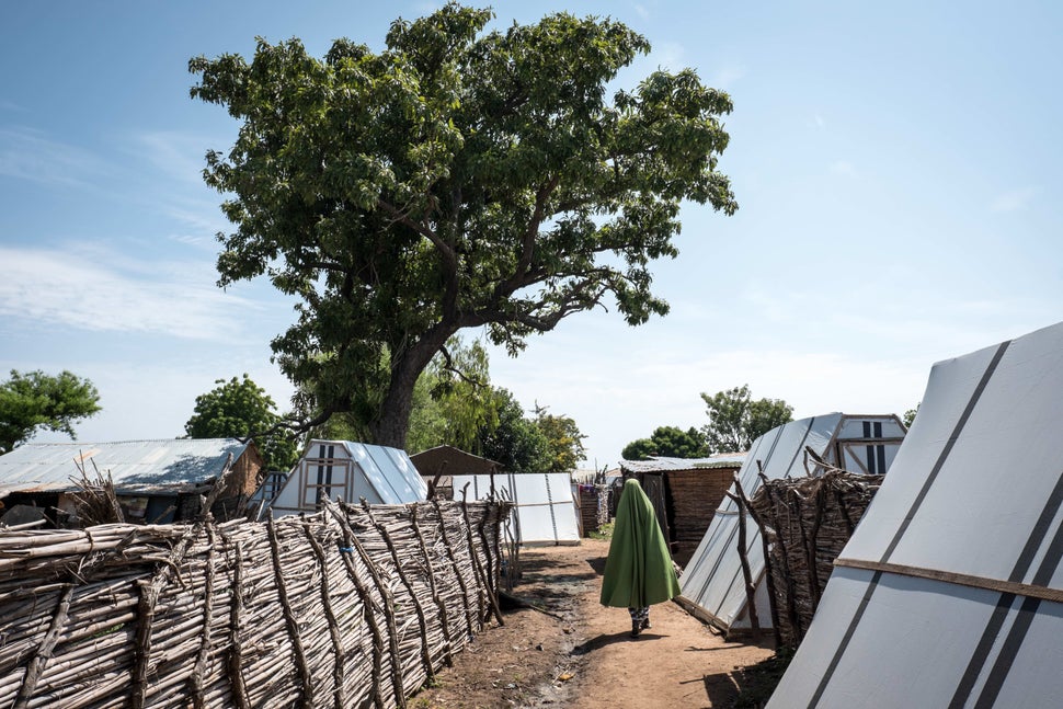 In Sabon Gari, a Nigerian woman displaced by Boko Haram walks in front of her tent.