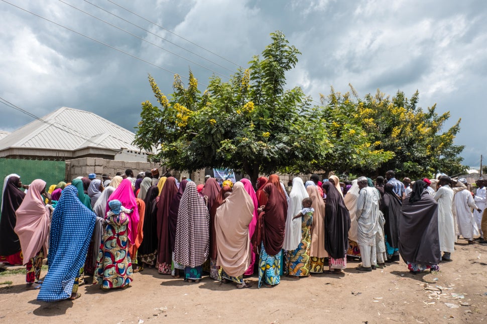 A crowd lines up to get Mercy Corps' e-vouchers in a neighborhood in Biu, Nigeria. The vouchers are worth 17,000 naira p