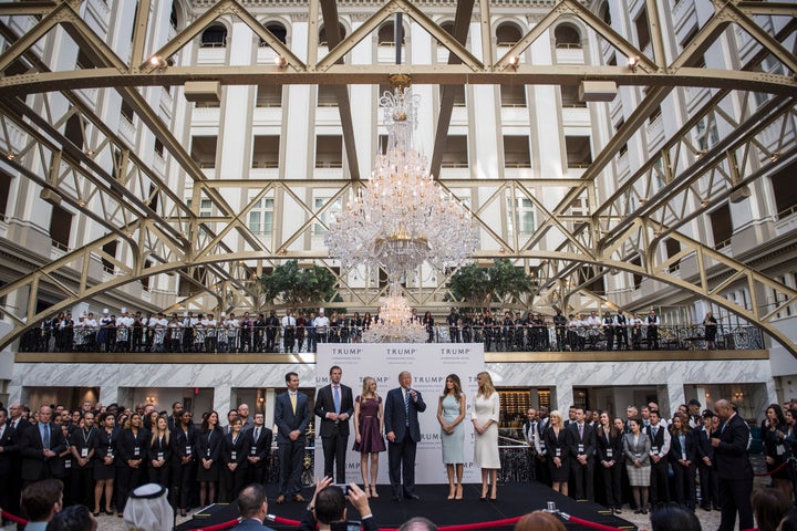 Republican presidential nominee Donald Trump and his adult children stage a ceremonial ribbon cutting for his new Washington, D.C., hotel this week. His campaign paid the hotel $13,342, although it was likely for an earlier press event he held there in September.