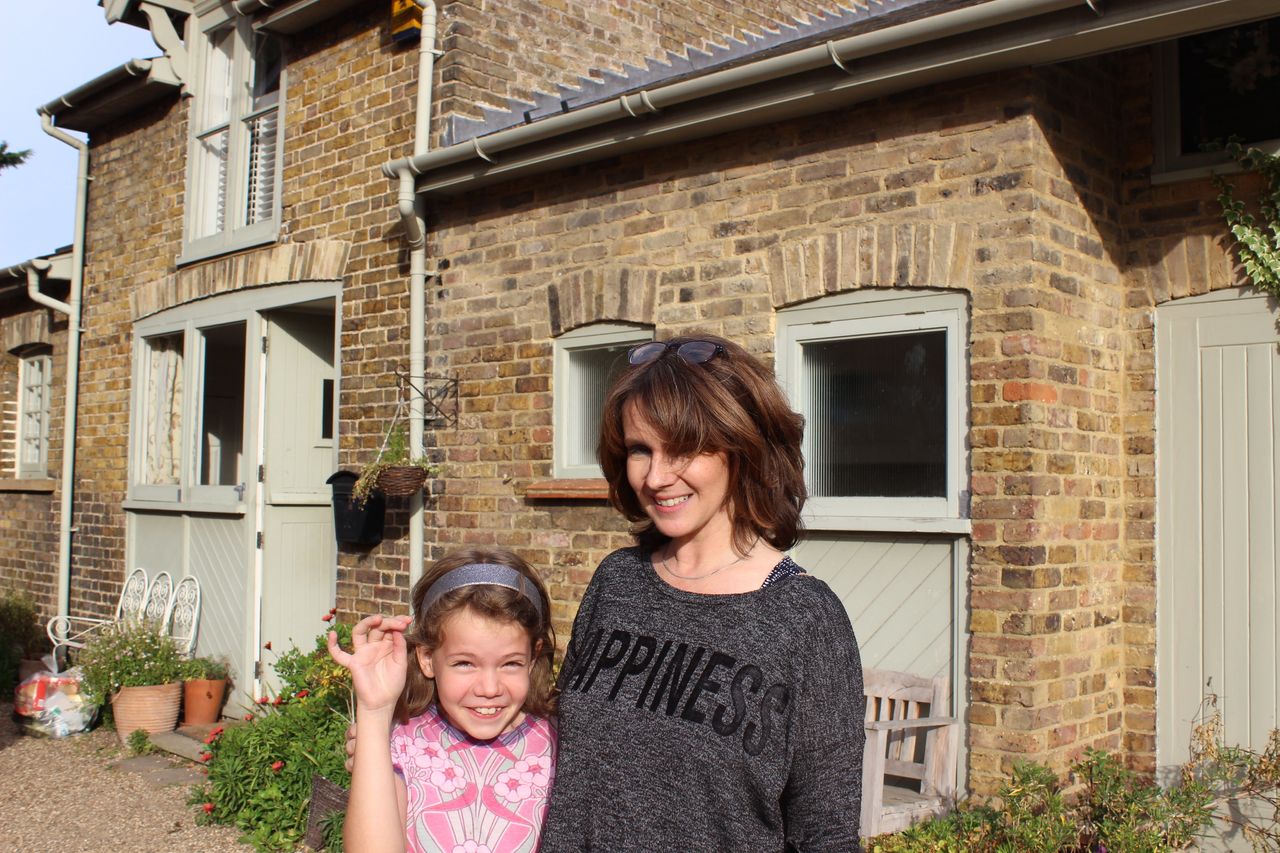 Emma Steele, right, and daughter Millie, 9, left, in front of the family home in Harmondsworth