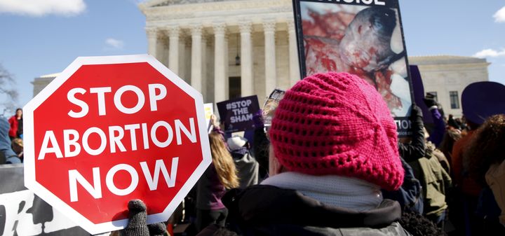 Protesters demonstrate in front of the U.S. Supreme Court on the morning that the court took up a major abortion case focusing on whether a Texas law that imposes strict regulations on abortion doctors and clinic buildings interferes with the constitutional right of a woman to end her pregnancy in Washington March 2, 2016.
