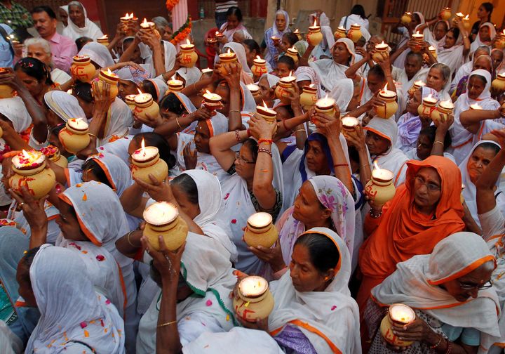 Widows, who have been abandoned by their families, carry earthen lamps as they gather inside a temple to celebrate Diwali, organised by non-governmental organisation Sulabh International in Vrindavan, India, October 27, 2016.