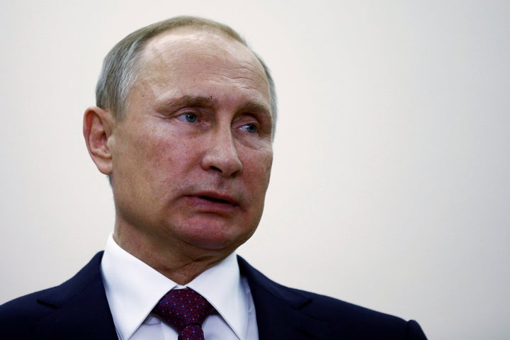 Russian President Vladimir Putin attends a press conference at Tegel airport after a meeting with German Chancellor Angela Me
