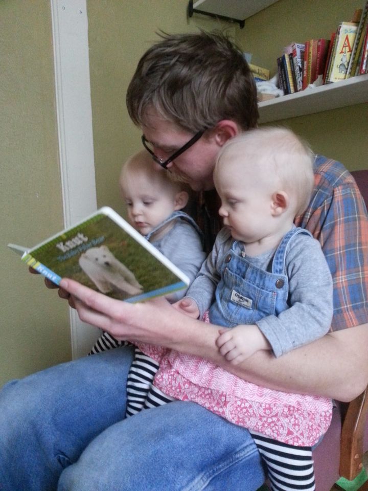 Sam reading to his daughters