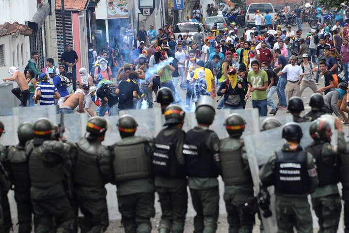 Demonstrators clash with members of Venezuelan National Guard during a rally demanding a referendum to remove Venezuela's Pre