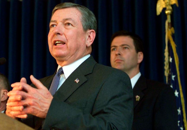 James Comey, then U.S. Attorney for the Southern District of New York, stands behind&nbsp;Attorney General...