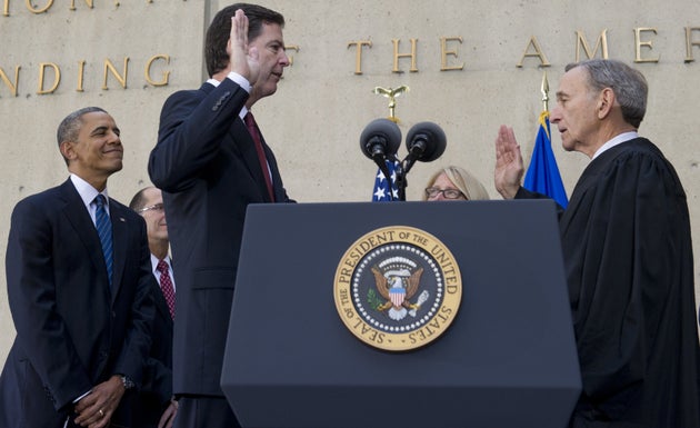 President Barack Obama looks on as James Comey is sworn in&nbsp;as the FBI director in a ceremony on...