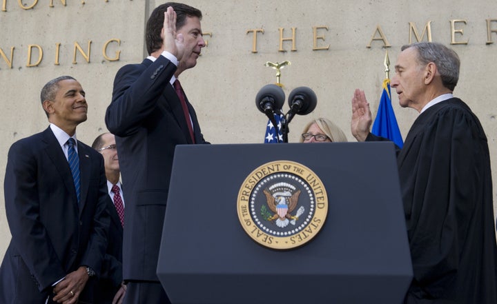 President Barack Obama looks on as James Comey is sworn in as the FBI director in a ceremony on Oct. 28, 2013.