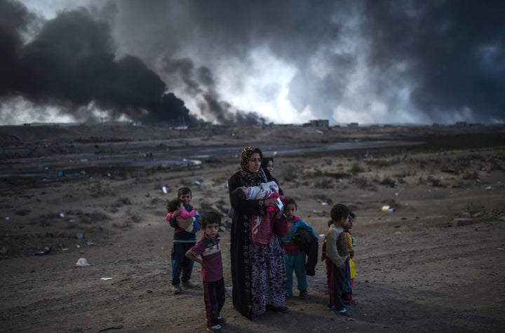 Iraqi families displaced by the US-backed and Iraqi-led operation against the Islamic State group to retake Mosul are seen near Qayyarah, south of Mosul, on Oct. 29.