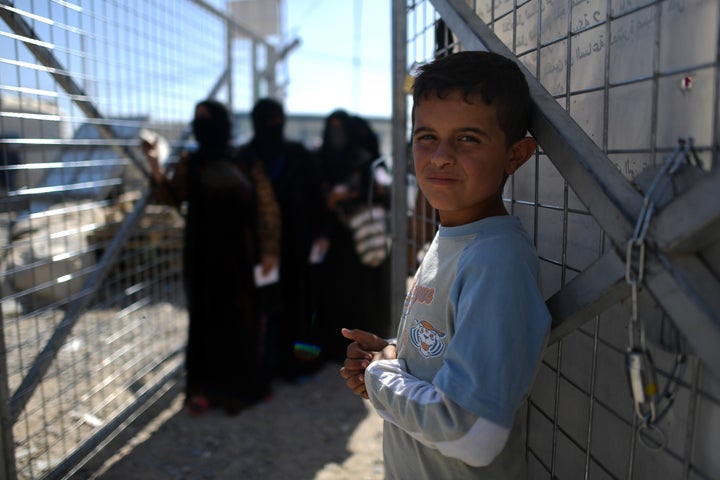 Iraqi women and children line up for food and hygiene kits at Debaga camp in northern Iraq on Oct. 21.