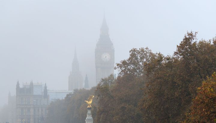 Big Ben peeking through thick fog 