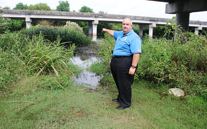 St. John the Baptist Sheriff's Office Major C.J. Destor points to where Karen Ivester's body was found in LaPlace, Louisiana.