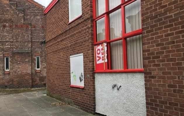 The smashed window at Wallasey constituency Labour party's offices