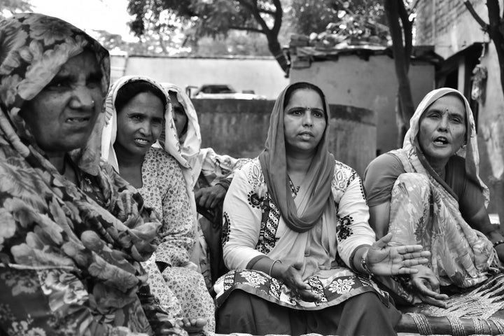 Mewat Radio supervisor and senior reporter Sunita Mishra, center, sits with Hoora Begum, second from left, and other women to discuss issues for Radio Mewat’s next broadcast.