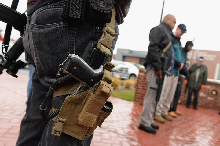 Open carry gun activists participate in a march in front of the city police department and municipal court on November 16, 2015 in Ferguson, Missouri.