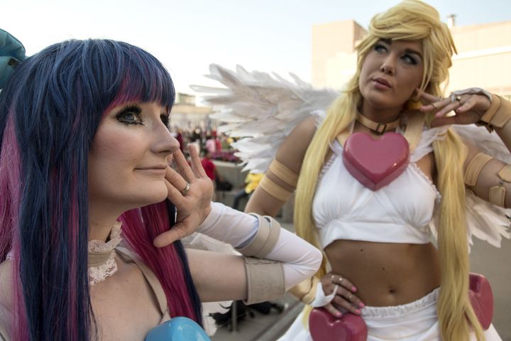 Two attendees of MomoCon, an anime, gaming and comic convention, practice their poses outside of the Georgia World Congress Center in May 2016, in Atlanta.
