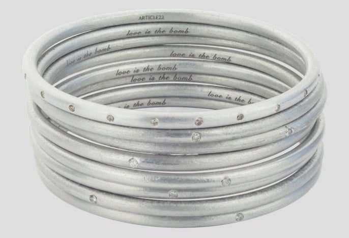 The Article 22 pieces bear messages that allude to the war in Laos. "Love is the bomb" is inscribed on the bangles