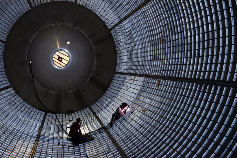 Welders put the finishing touches on the inner side of an SLS hydrogen fuel tank. This particular tank is a qualification uni