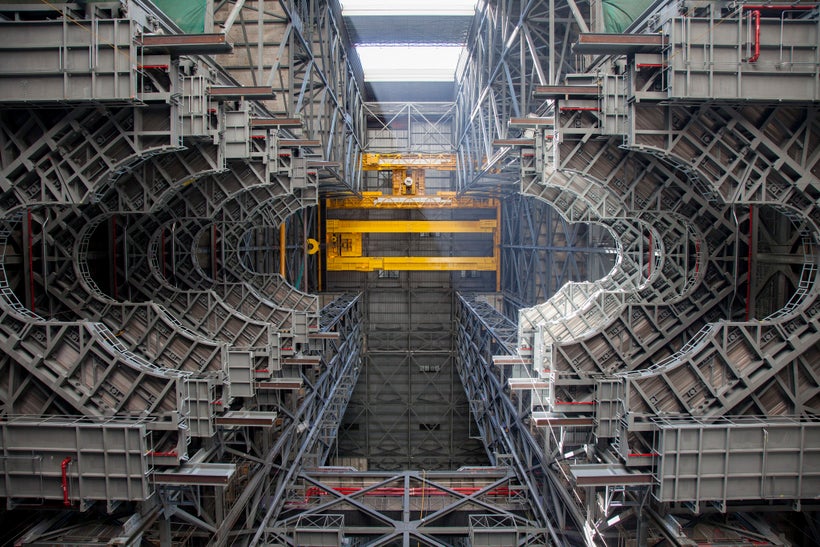 New SLS work platforms line the inside of a former space shuttle bay in the Vehicle Assembly Building at NASA’s Kennedy Space
