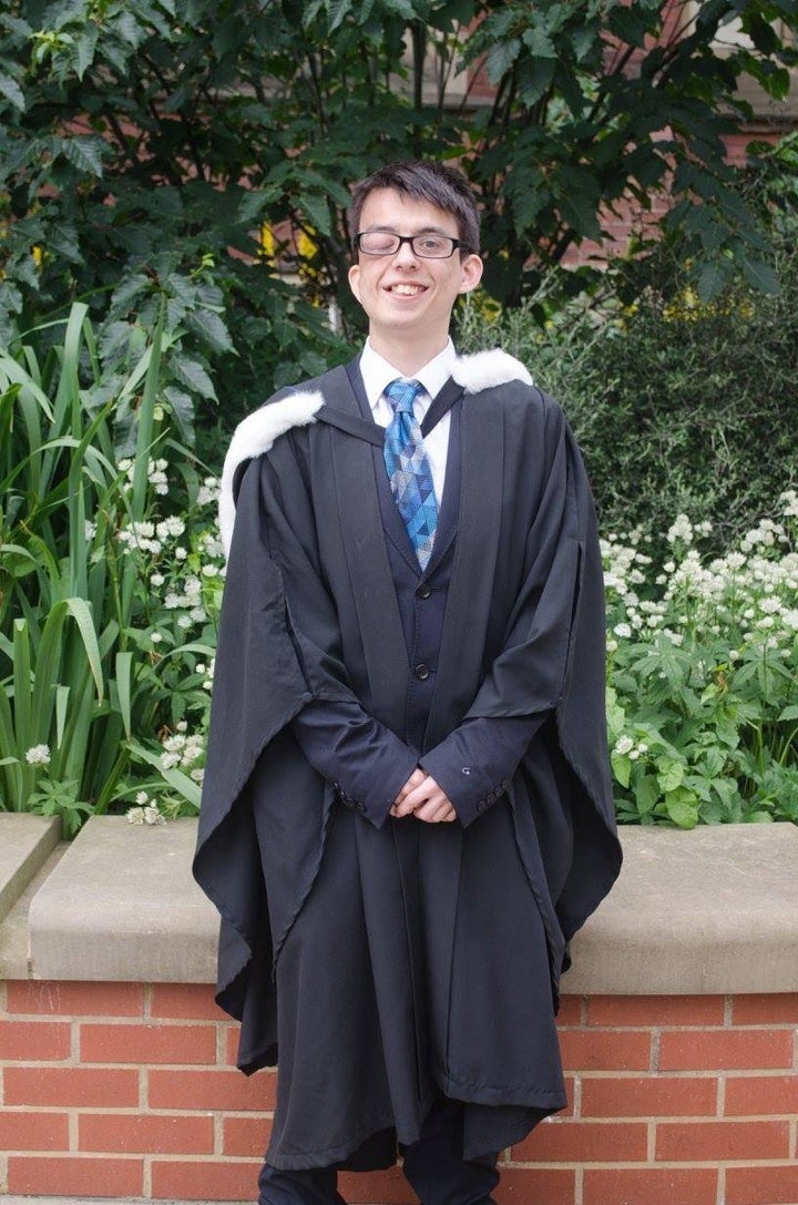 David White smiling proudly on the day of his graduation.