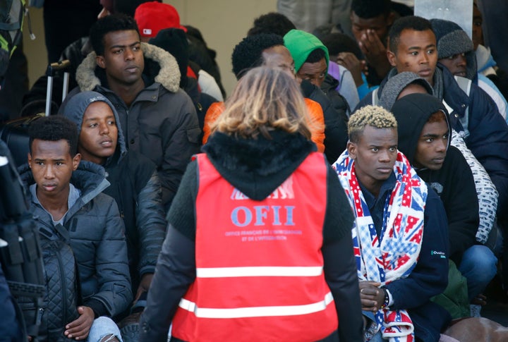 Migrant minors queue to take a bus before their transfer by French authorities to reception centres across the country at the end of the dismantlement of the camp called the